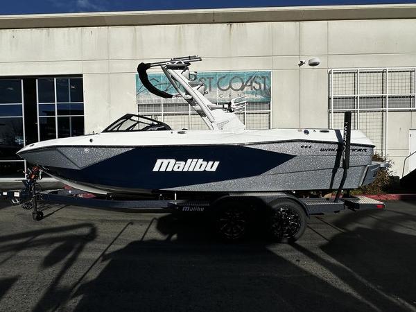 Malibu Wakesetter 23 LSV 2025 Malibu Wakesetter 23 LSV boat on trailer, parked outside a building.