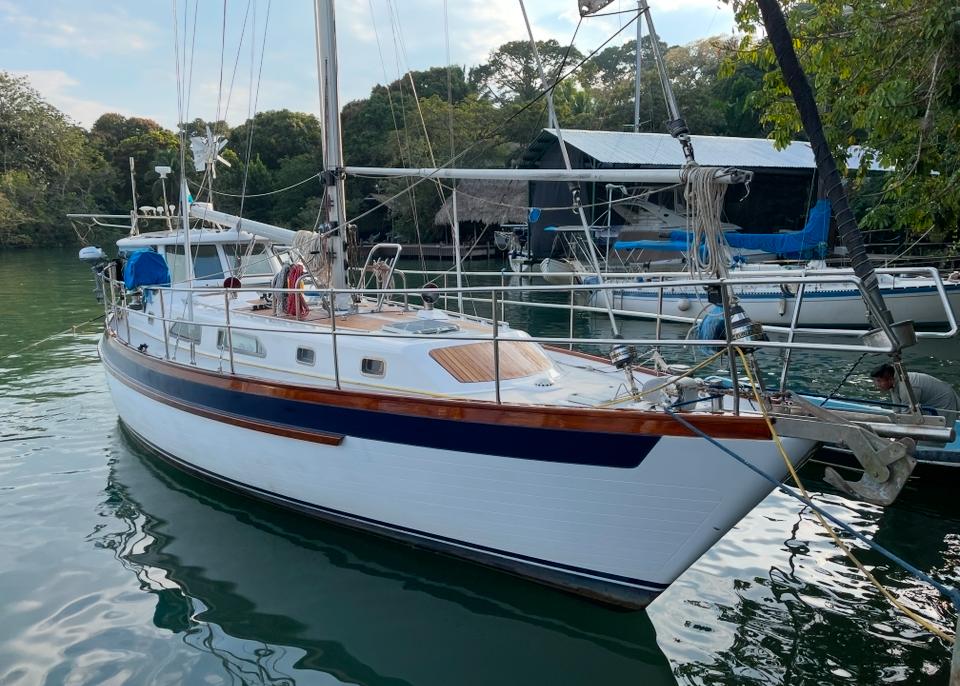 Slocum 43 Cutter 1984 Slocum 43 Cutter sailboat docked in a serene marina setting.
