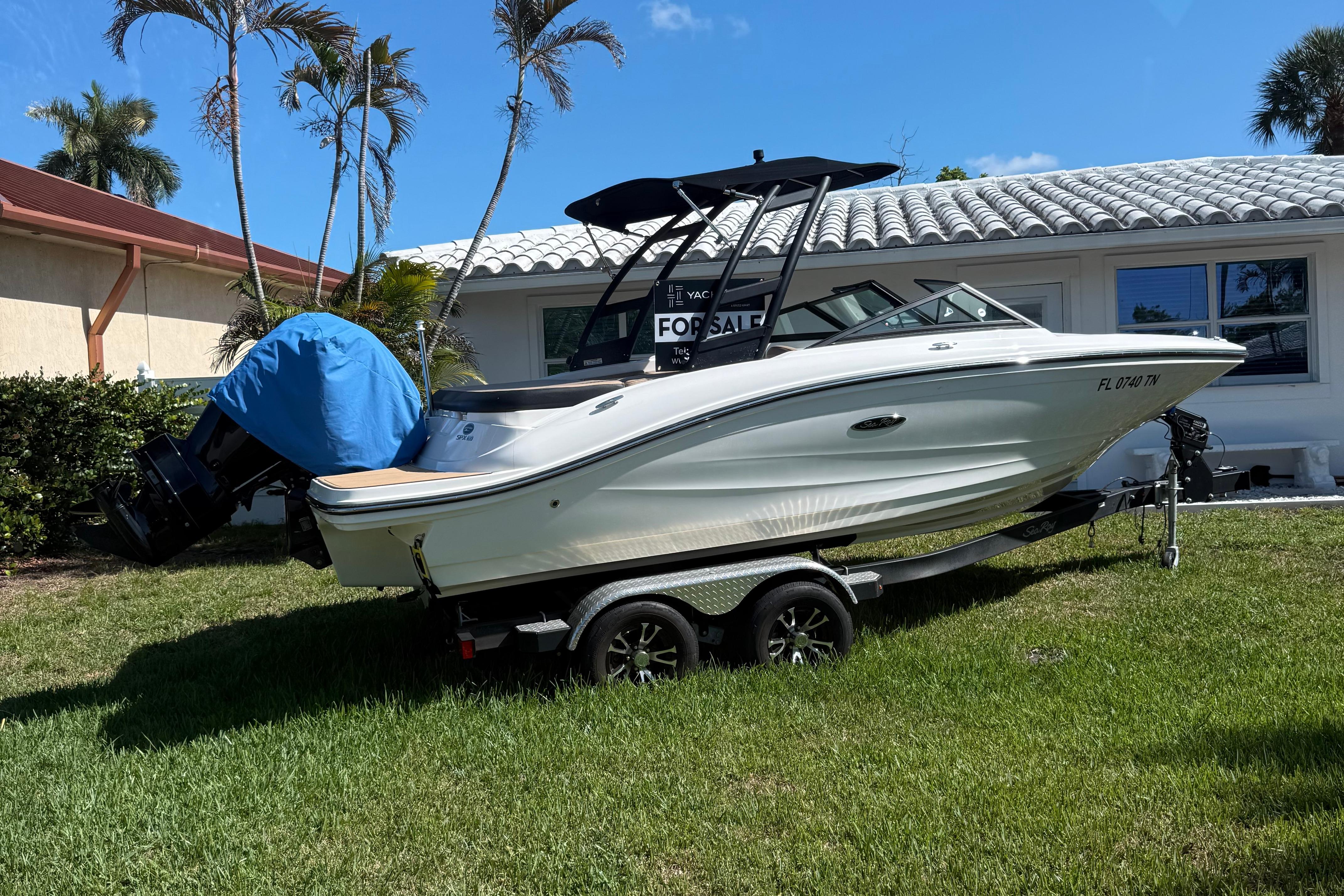 Sea Ray SPX 190 Outboard 2023 Sea Ray SPX 190 Outboard boat on trailer, parked on grass, with "For Sale" sign.