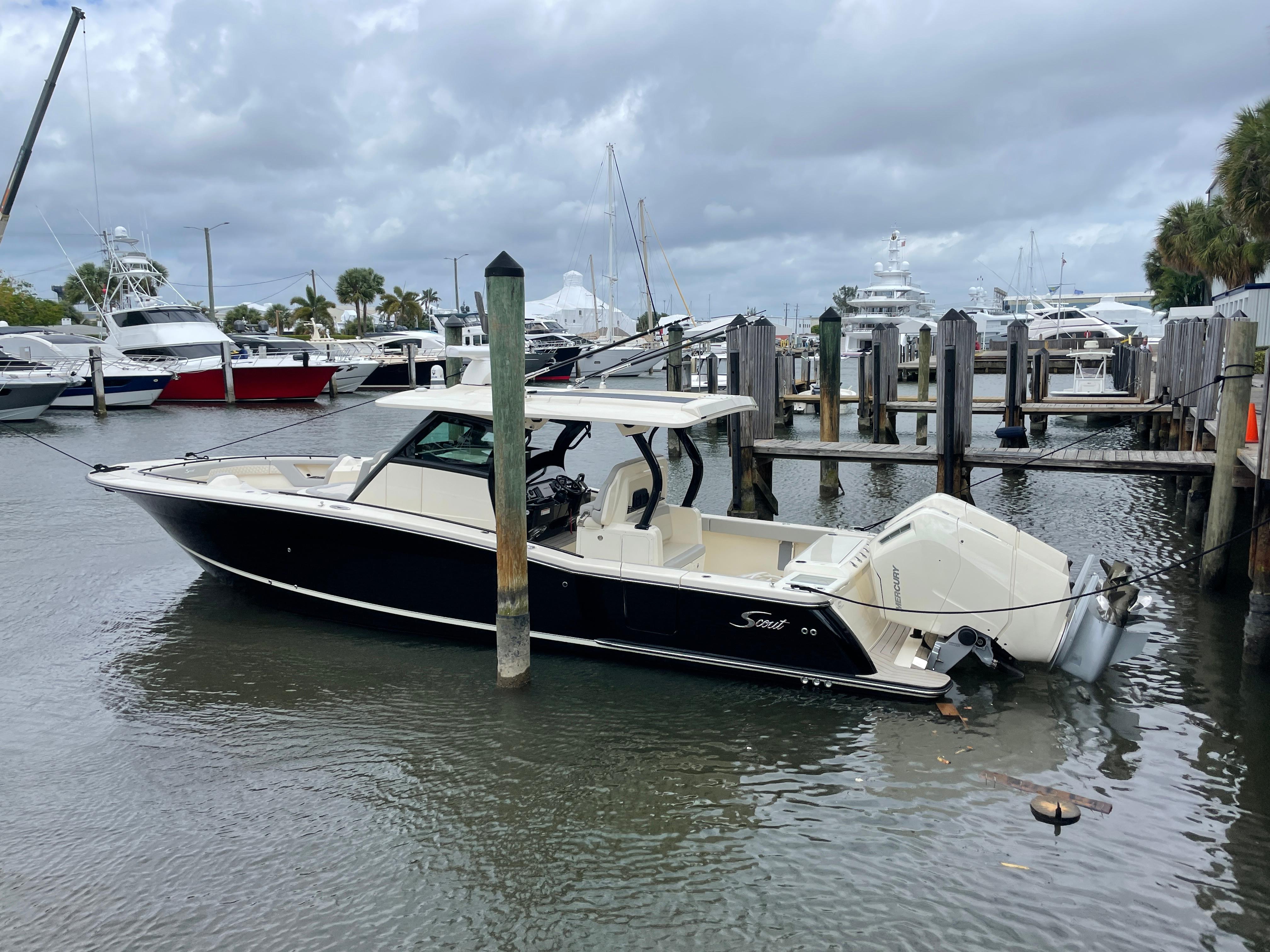 Scout 377 LXF 2025 Scout 377 LXF boat docked at a marina on a cloudy day.