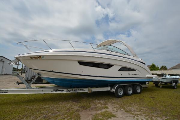 Regal 33XO 2018 Regal 33XO boat on trailer, side view, cloudy sky background.