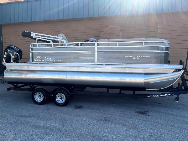 Sun Tracker Party Barge 20 DLX 2025 Sun Tracker Party Barge 20 DLX pontoon boat on trailer.