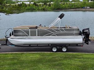 Sylvan Mirage Fish 822 Party Fish 2022 Sylvan Mirage Fish 822 Party Fish pontoon boat on trailer by a lake.