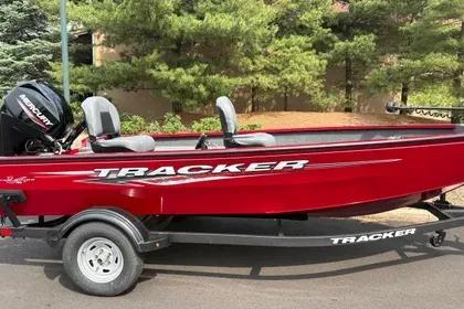 Tracker Super Guide V-16 T 2025 Tracker Super Guide V-16 T boat in red on a trailer, parked outdoors.