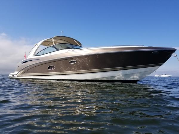 Formula 350 Crossover Bowrider 2014 Formula 350 Crossover Bowrider on calm water under clear blue sky.