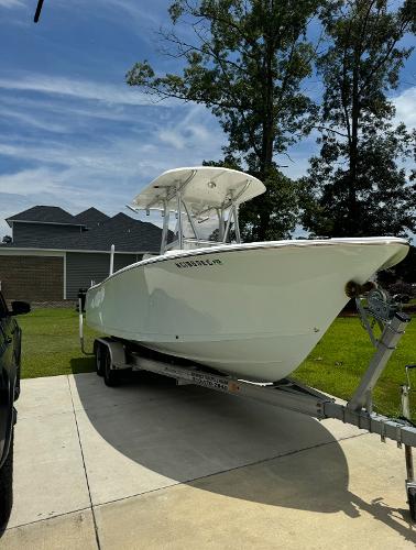 Sea Hunt Ultra 234 2016 Sea Hunt Ultra 234 boat on a trailer in a driveway.