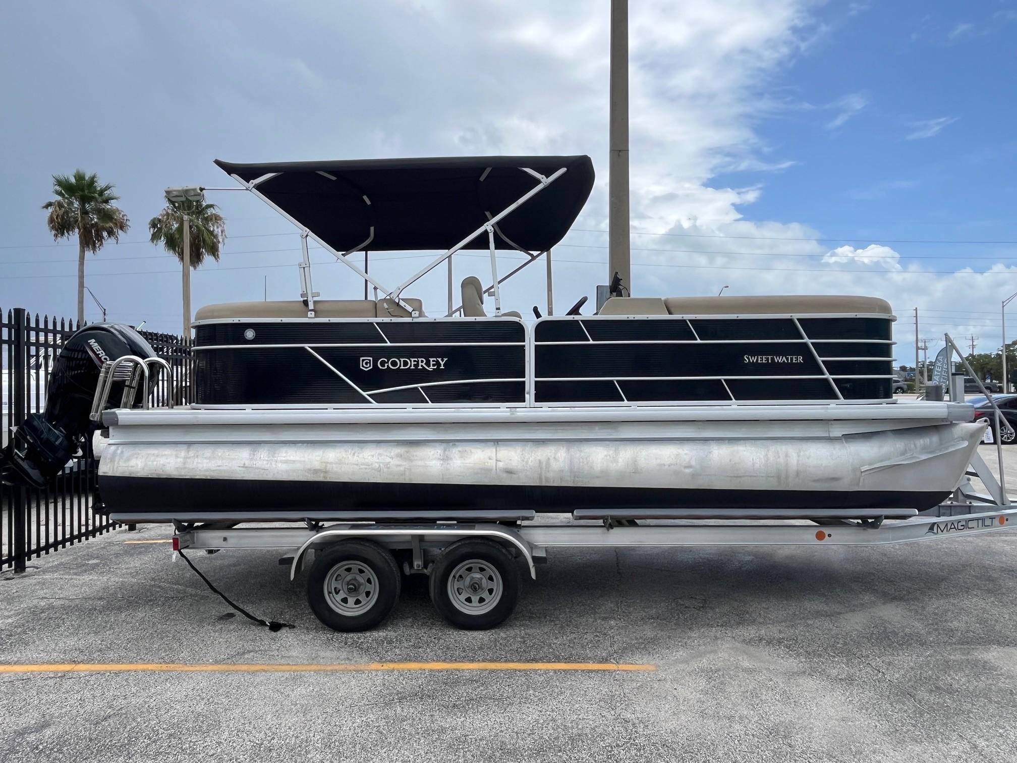 Godfrey Sweetwater 2286 FS 2022 Godfrey Sweetwater 2286 FS pontoon boat on trailer, parked outdoors.