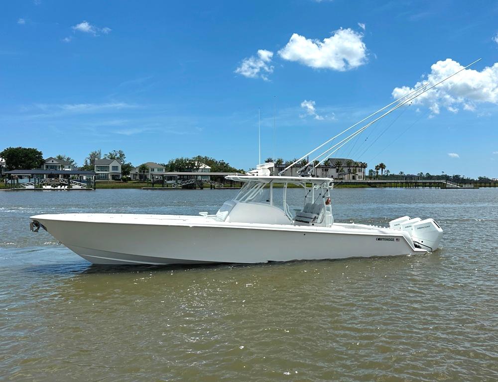 Contender 39 Fisharound 2021 Contender 39 Fisharound boat on calm water under a clear blue sky.