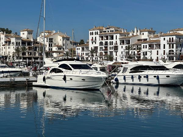 Astondoa AS 43 GLX Luxury yachts, including a 2006 Astondoa AS 43 GLX, docked in a scenic marina.