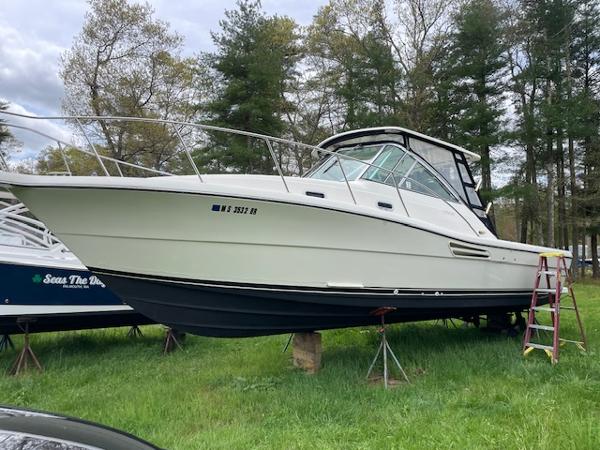 Pursuit 3000 Express 2002 Pursuit 3000 Express boat on stands, surrounded by trees.