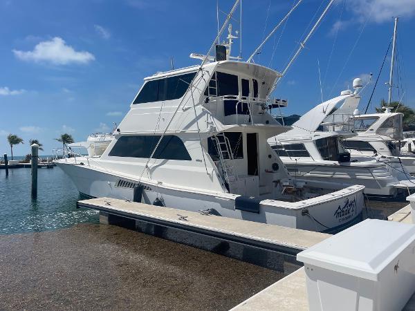 Viking Yachts 58 EB 1999 Viking 58 EB yacht docked at marina under clear blue sky.