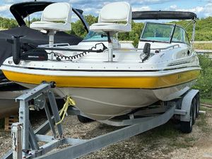 Hurricane SunDeck 237 OB 2012 Hurricane SunDeck 237 OB boat on trailer, featuring yellow accents and dual seats.