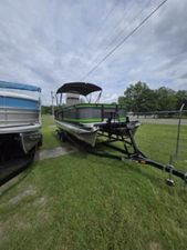 Qwest 20 XRE FISH 2025 Qwest 20 XRE FISH pontoon boat on trailer, parked on grass.