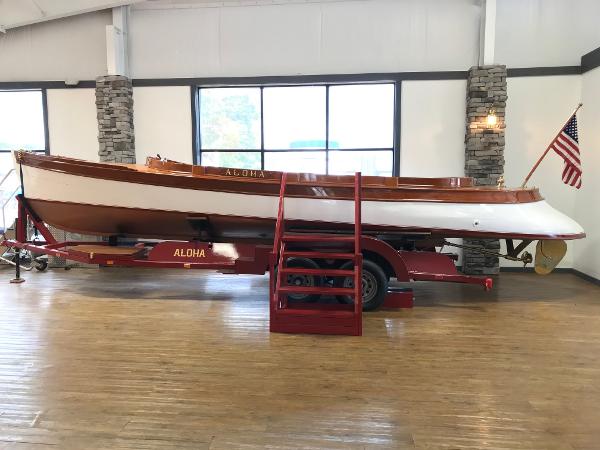 New York Launch 20 Vintage 1905 New York Launch 20 boat Aloha on display indoors.