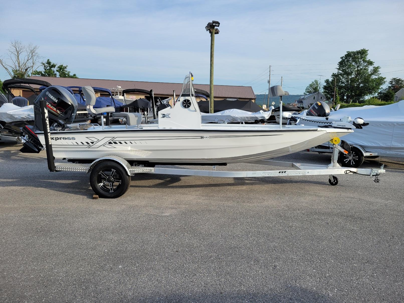 Xpress H190 Bay boat w/ Yamaha Vmax 115 2025 Xpress H190 Bay Boat on trailer, parked outdoors, side view.