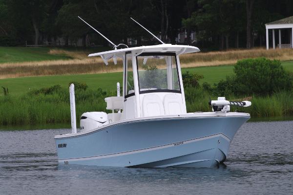 Regulator 24XO 2025 Regulator 24XO boat on calm water with lush greenery in the background.
