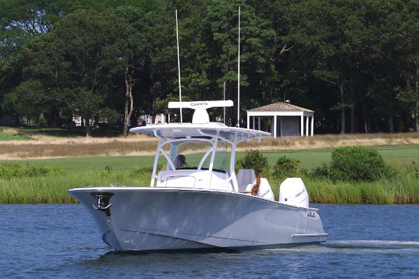 Valhalla Boatworks V-33 2025 Valhalla Boatworks V-33 cruising on a serene lake with lush greenery.