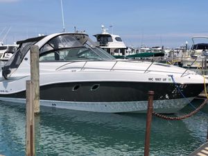 Rinker 310 Express Cruiser 2013 Rinker 310 Express Cruiser docked in a marina, surrounded by other boats.
