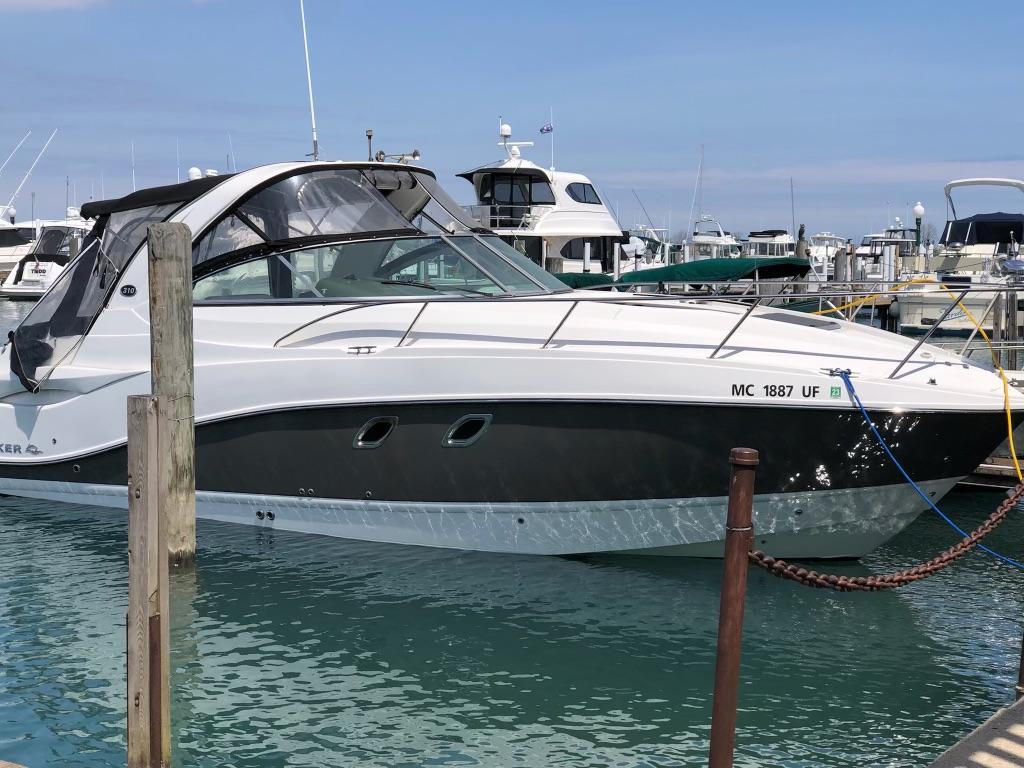 Rinker 310 Express Cruiser 2013 Rinker 310 Express Cruiser docked in a marina, surrounded by other boats.