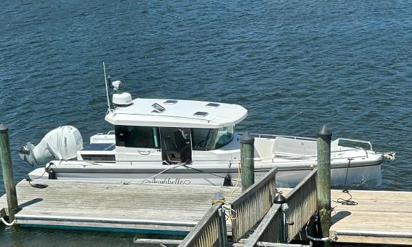 Axopar CABIN 2018 Axopar Mark II boat docked at a marina.
