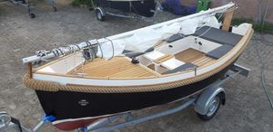 Damarin 13 Damarin 13 sailboat on trailer, 2017 model, with wooden deck and black hull.