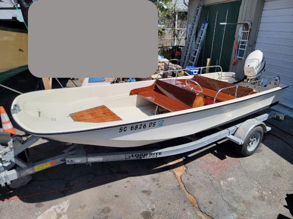 Boston Whaler 17 Sport, 2015 E-Tec 90, teak 1977 Boston Whaler 17 Sport boat with 2015 E-Tec 90 engine on trailer.
