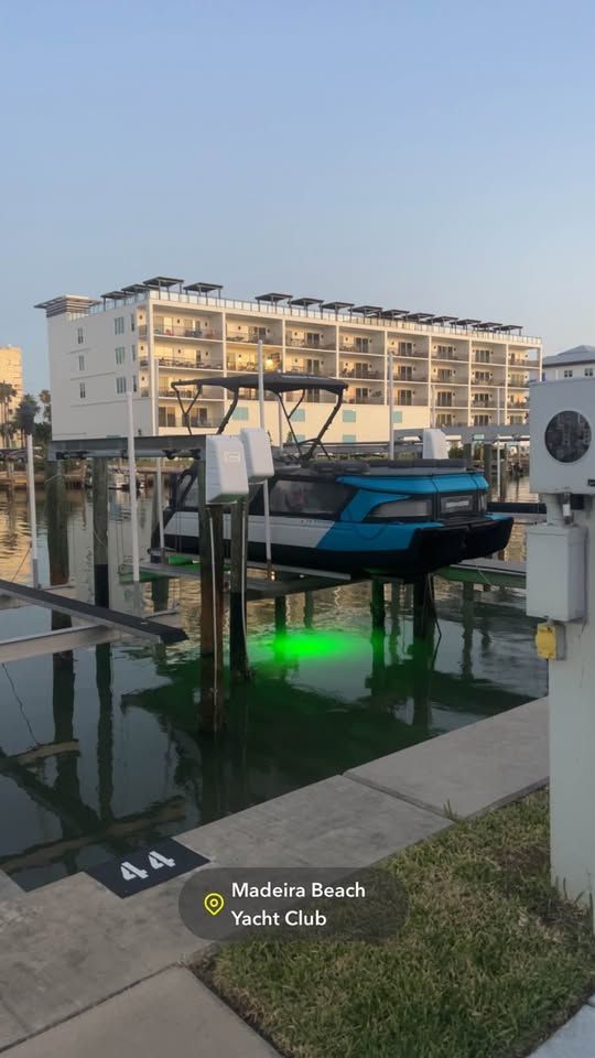 Custom Switch Custom 2023 Switch boat docked at Madeira Beach Yacht Club with green underwater lights.
