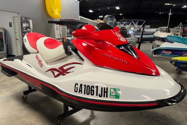 Sea-Doo Wake 2006 Sea-Doo Wake jet ski in showroom, red and white design, side view.