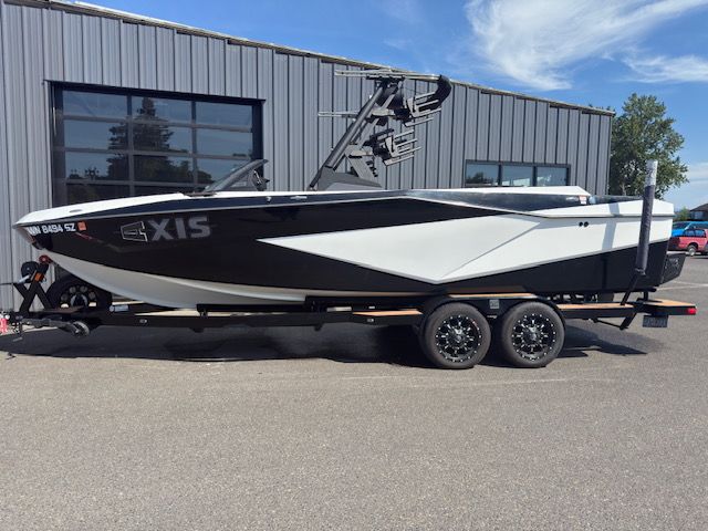 Axis T250 2022 Axis T250 boat on trailer, parked outside industrial building.