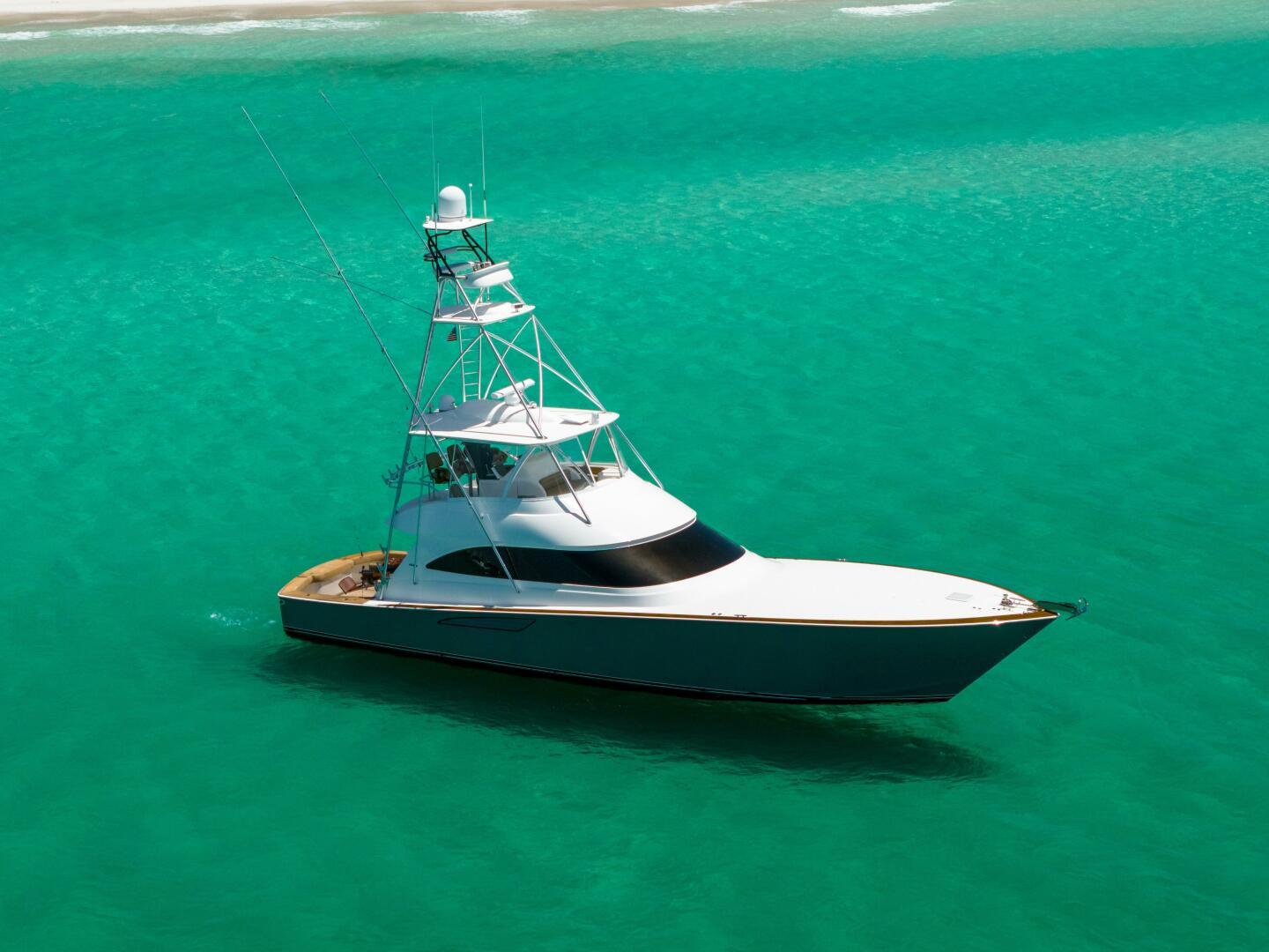 Viking 62 Convertible 2015 Viking 62 Convertible yacht on turquoise water near sandy beach.