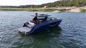 Cruisers Yachts 38 GLS I/O 2021 Cruisers Yachts 38 GLS I/O on a serene lake with lush shoreline.