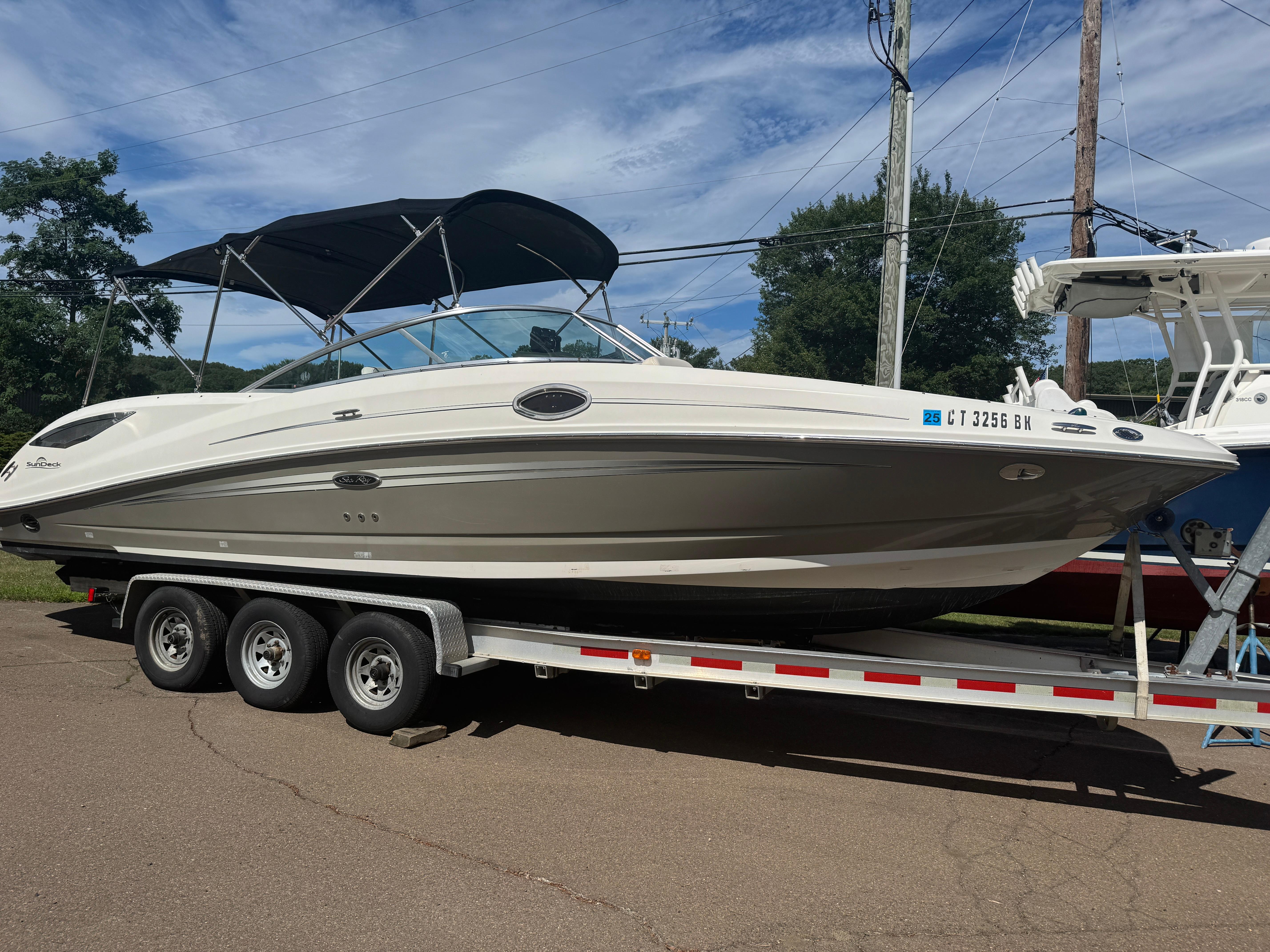 Sea Ray 290 Sundeck 2008 Sea Ray 290 Sundeck boat on trailer under blue sky.