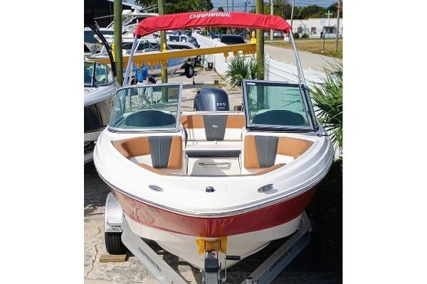 Chaparral 19 SSi OB 2024 Chaparral 19 SSi OB boat with red and white exterior on a trailer.