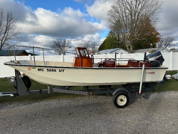 Boston Whaler NAUSET 17 1973 Boston Whaler NAUSET 17 boat on trailer, parked outdoors under cloudy sky.