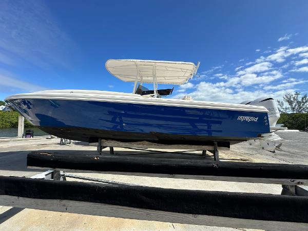 Intrepid 323 2005 Intrepid 323 boat on trailer under clear blue sky.