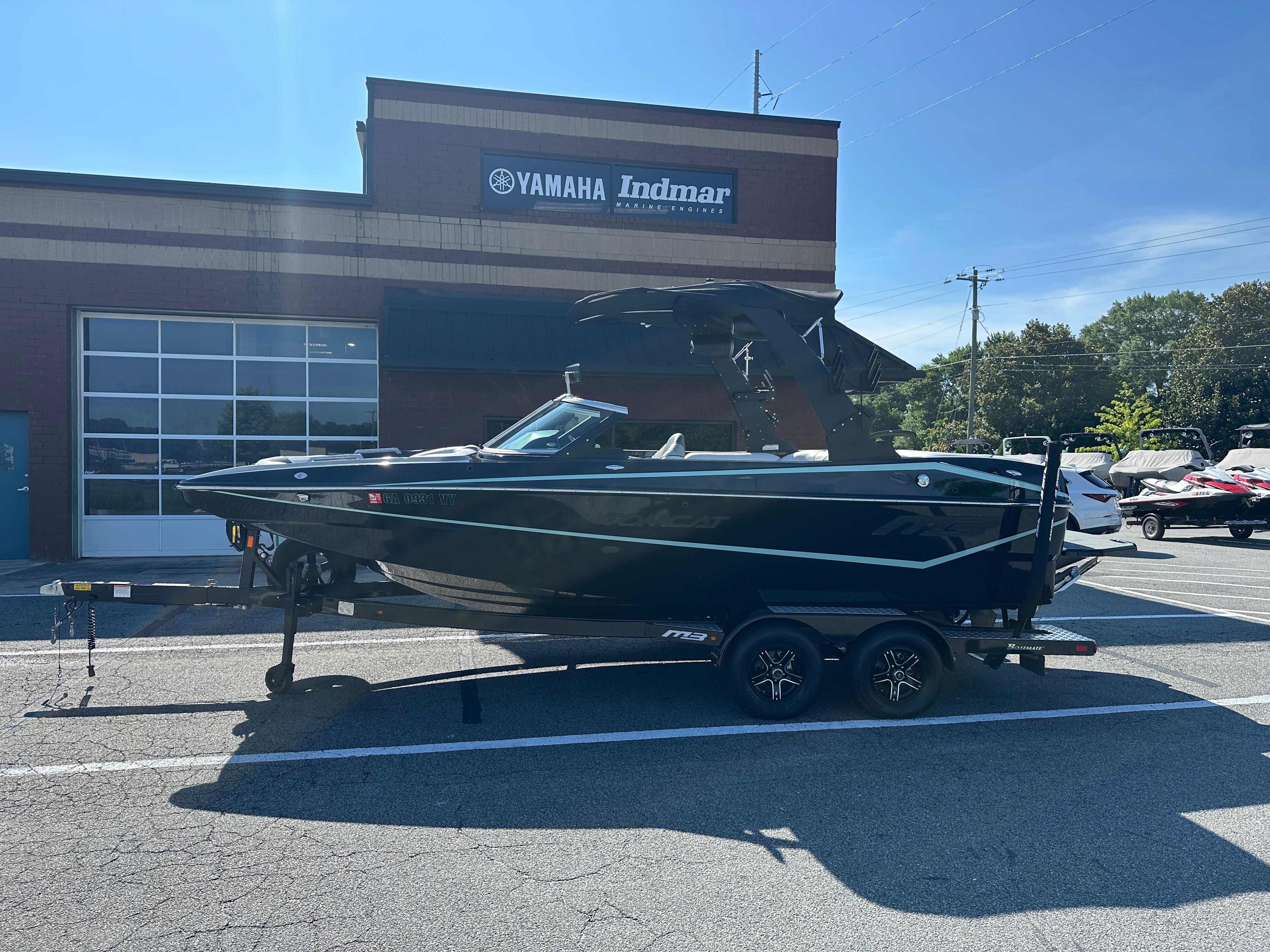 MB F21 Tomcat Classic 2022 MB F21 Tomcat Classic boat on trailer outside Yamaha Indmar dealership.