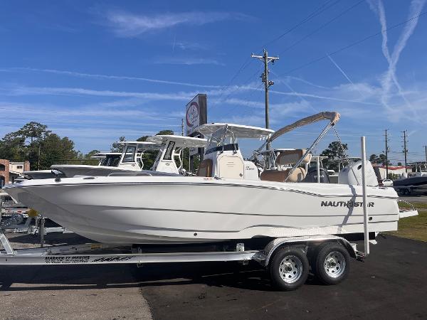 NauticStar 211 Hybrid 2025 NauticStar 211 Hybrid boat on trailer under clear blue sky.