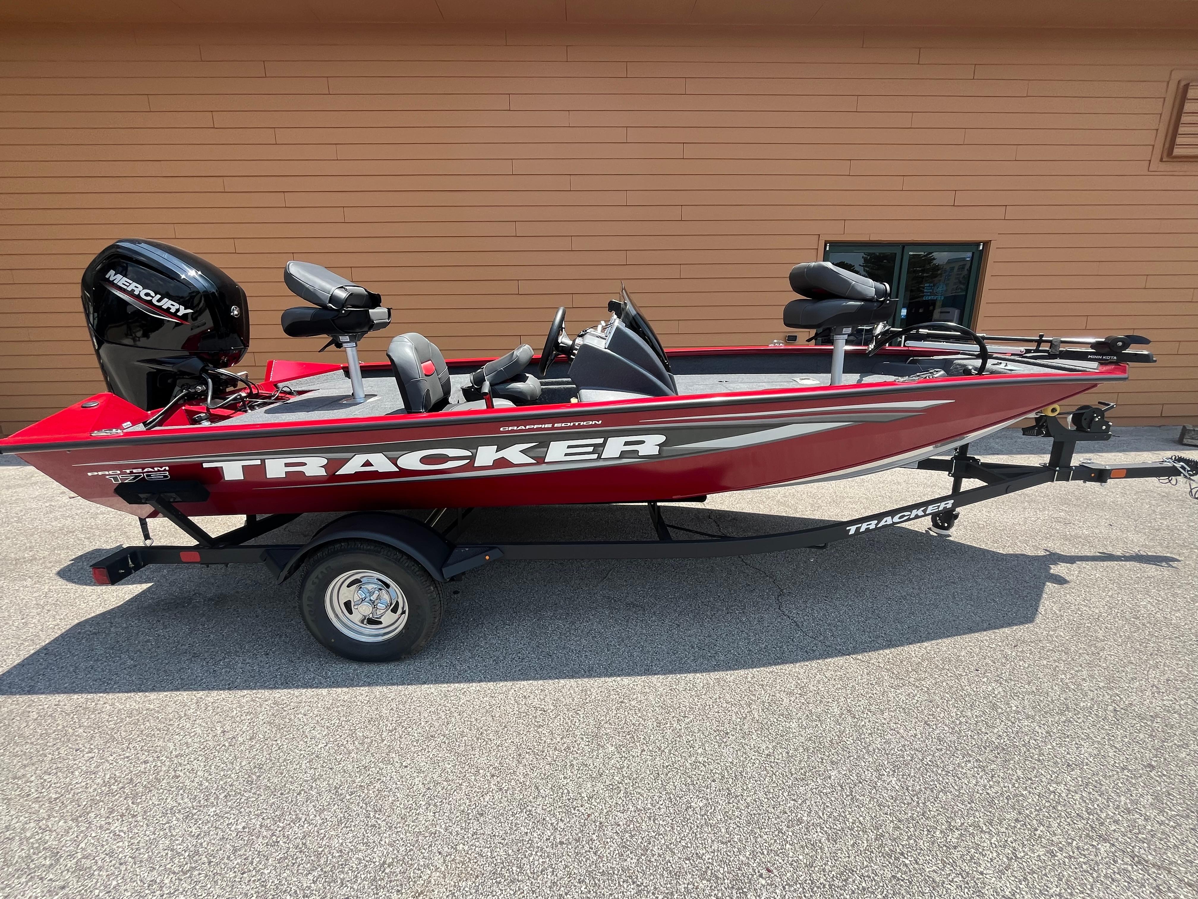 Tracker Pro Team 175 Crappie Edition 2025 Tracker Pro Team 175 Crappie Edition boat, red, on trailer, side view.