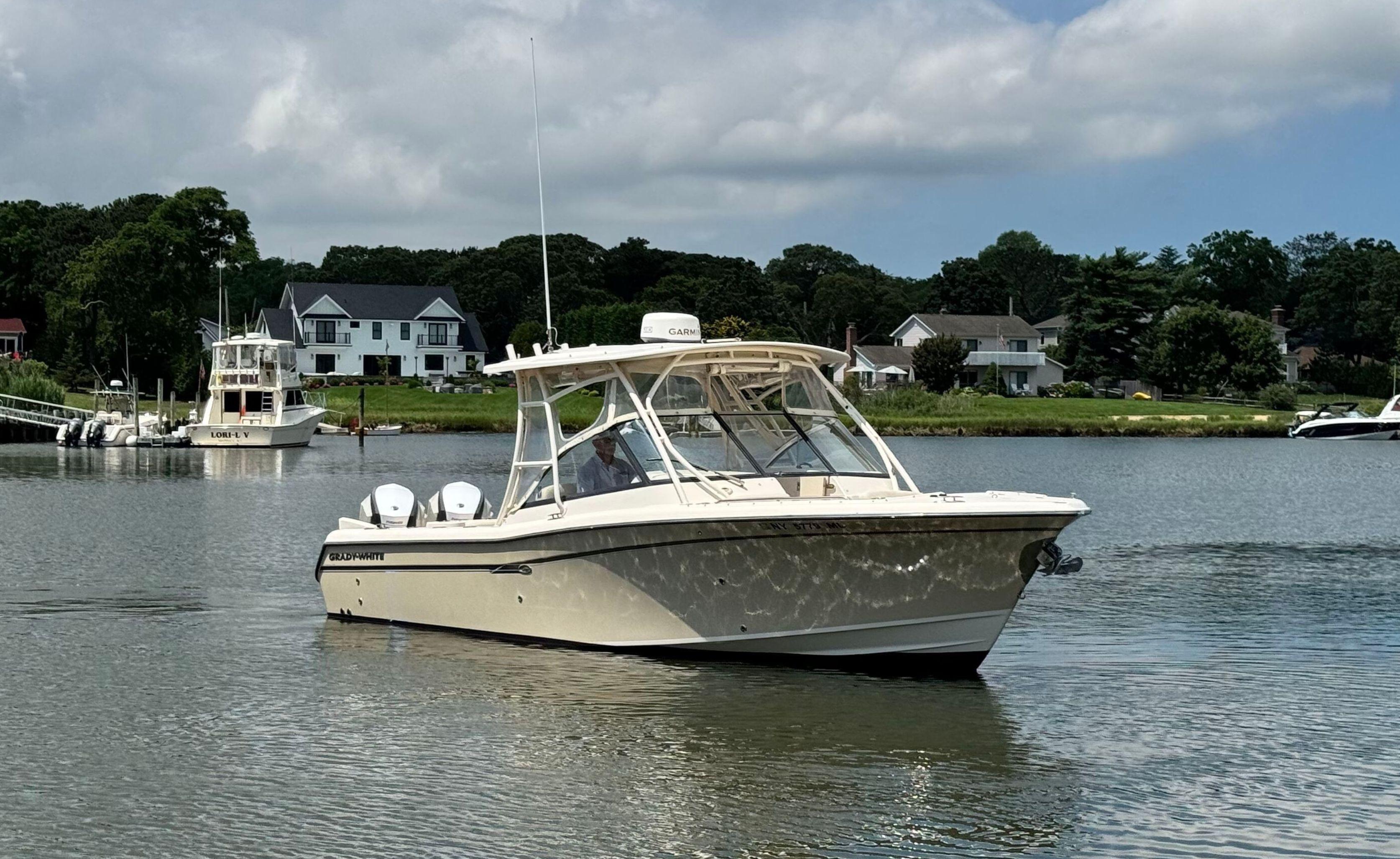 Grady-White Freedom 285 2016 Grady-White Freedom 285 boat on calm water near residential shoreline.