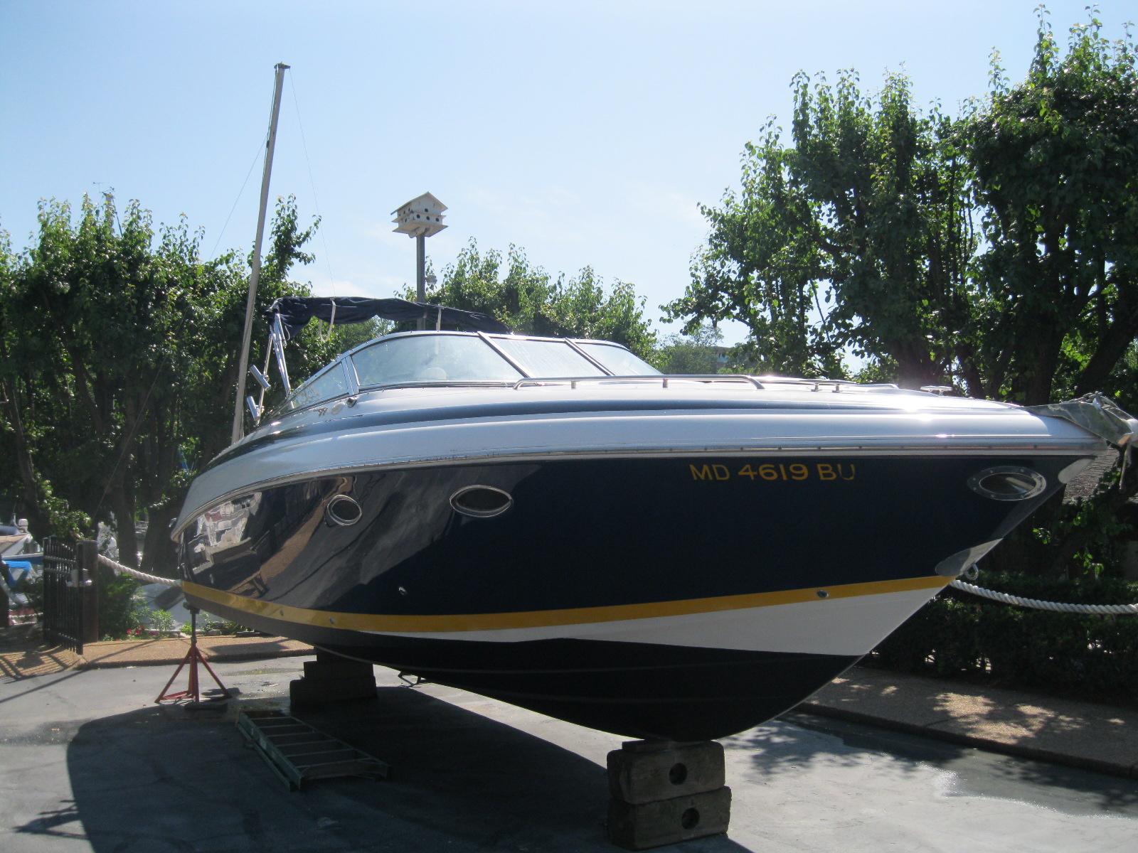 Cobalt 293 2003 Cobalt 293 boat on dry dock, surrounded by trees, with registration number MD 4619 BU.