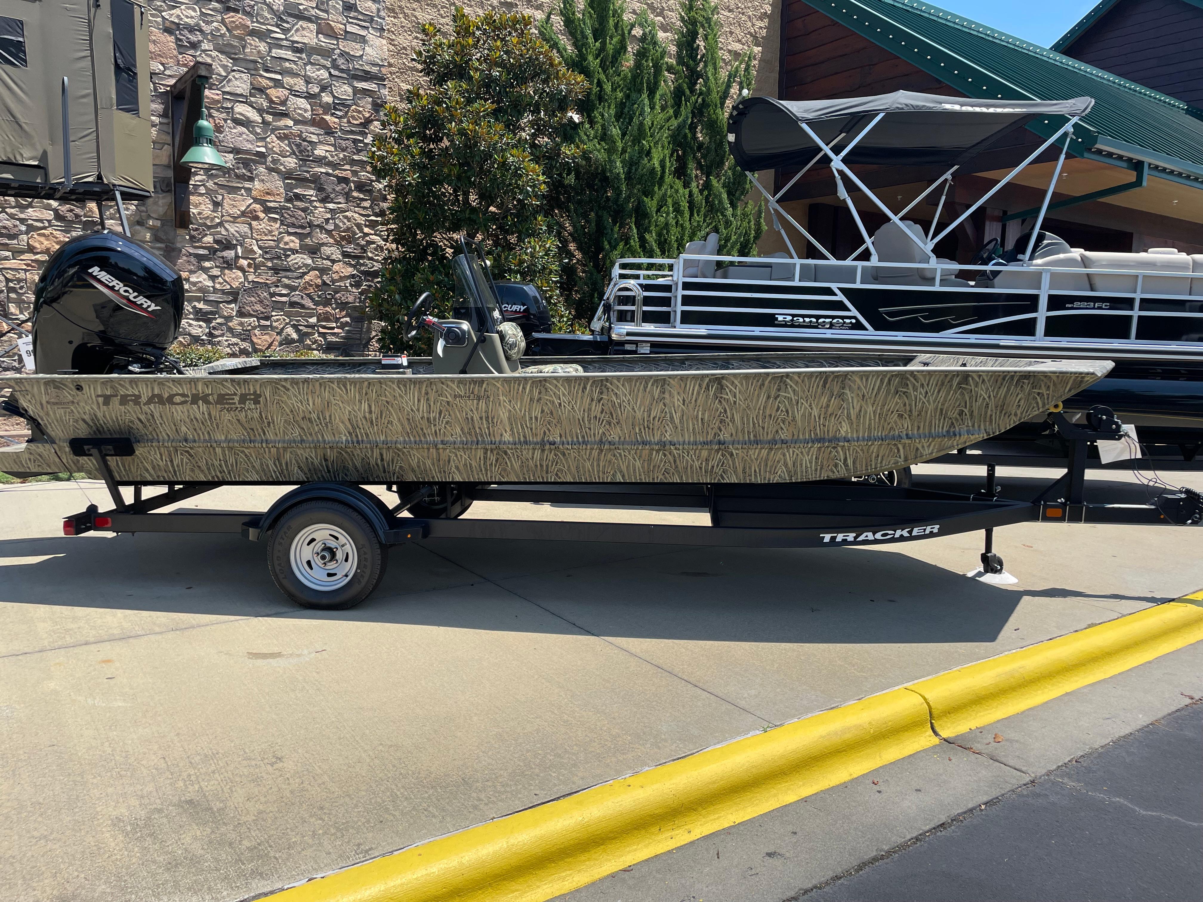 Tracker Grizzly 2072 CC 2025 Tracker Grizzly 2072 CC boat on trailer, parked outdoors.