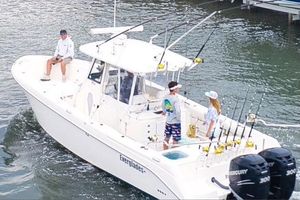 Everglades 325 Center Console 2012 Everglades 325 Center Console boat with passengers, equipped for fishing, on the water.