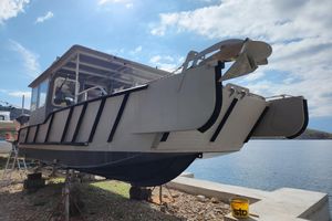 Custom LC 853 Aluminum boat ALUTEH LC 853, 2018 model, docked by the water under a clear sky.