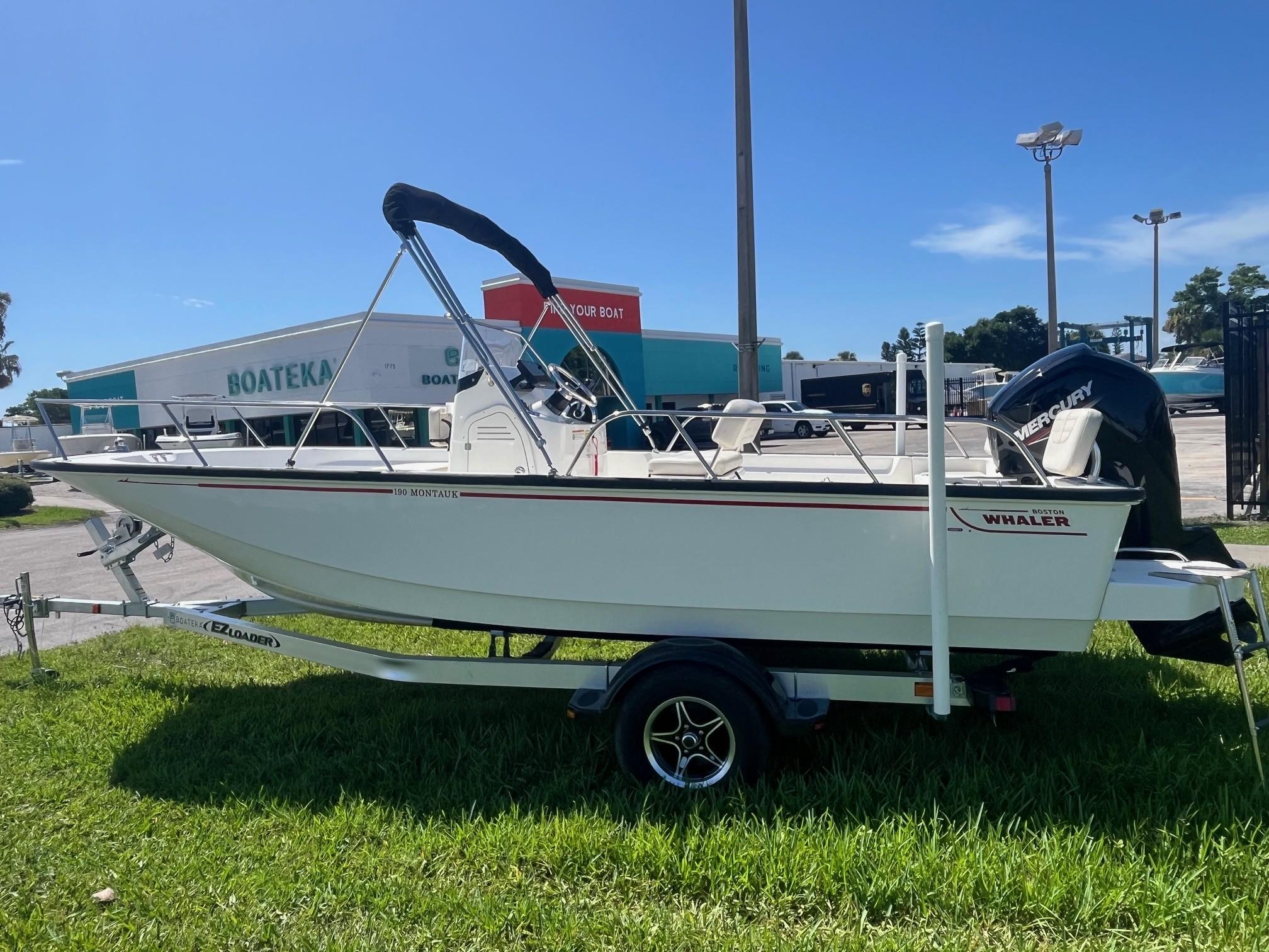 Boston Whaler 190 Montauk 2023 Boston Whaler 190 Montauk boat on trailer, displayed outdoors at dealership.