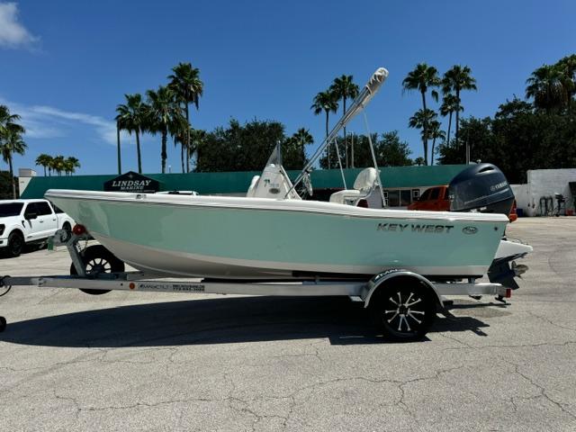 Key West 179 FS 2026 Key West 179 FS boat on trailer, parked outdoors with palm trees in the background.