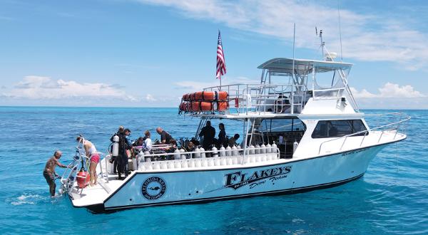 Newton 46 Dive Special Dive boat "Flakeys" with divers preparing, Newton 46 Dive Special, 2004, in clear blue ocean.
