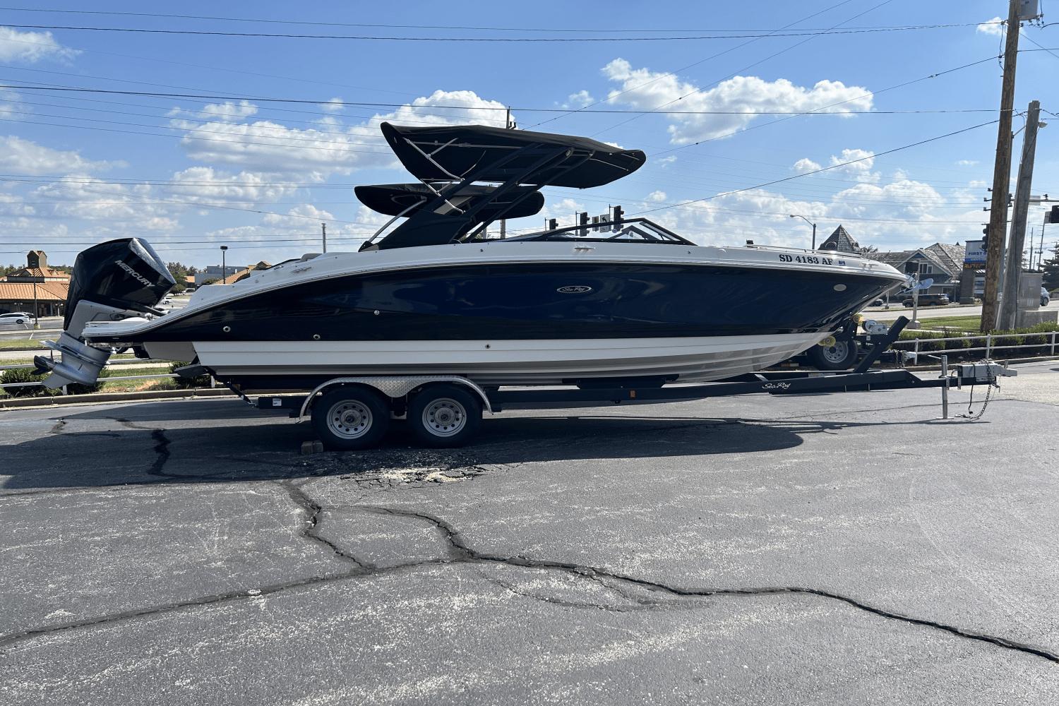 Sea Ray 270 Sundeck Outboard 2022 Sea Ray 270 Sundeck Outboard boat on trailer under blue sky.
