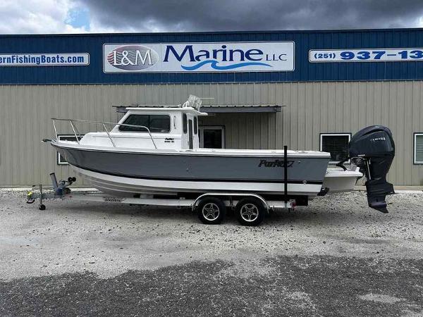 Parker 2420 SC 2026 Parker 2420 SC boat on trailer outside L&M Marine LLC building.