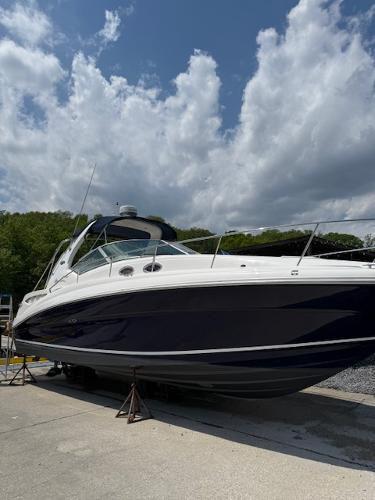 Sea Ray 320 Sundancer 2005 Sea Ray 320 Sundancer boat on stands under a partly cloudy sky.