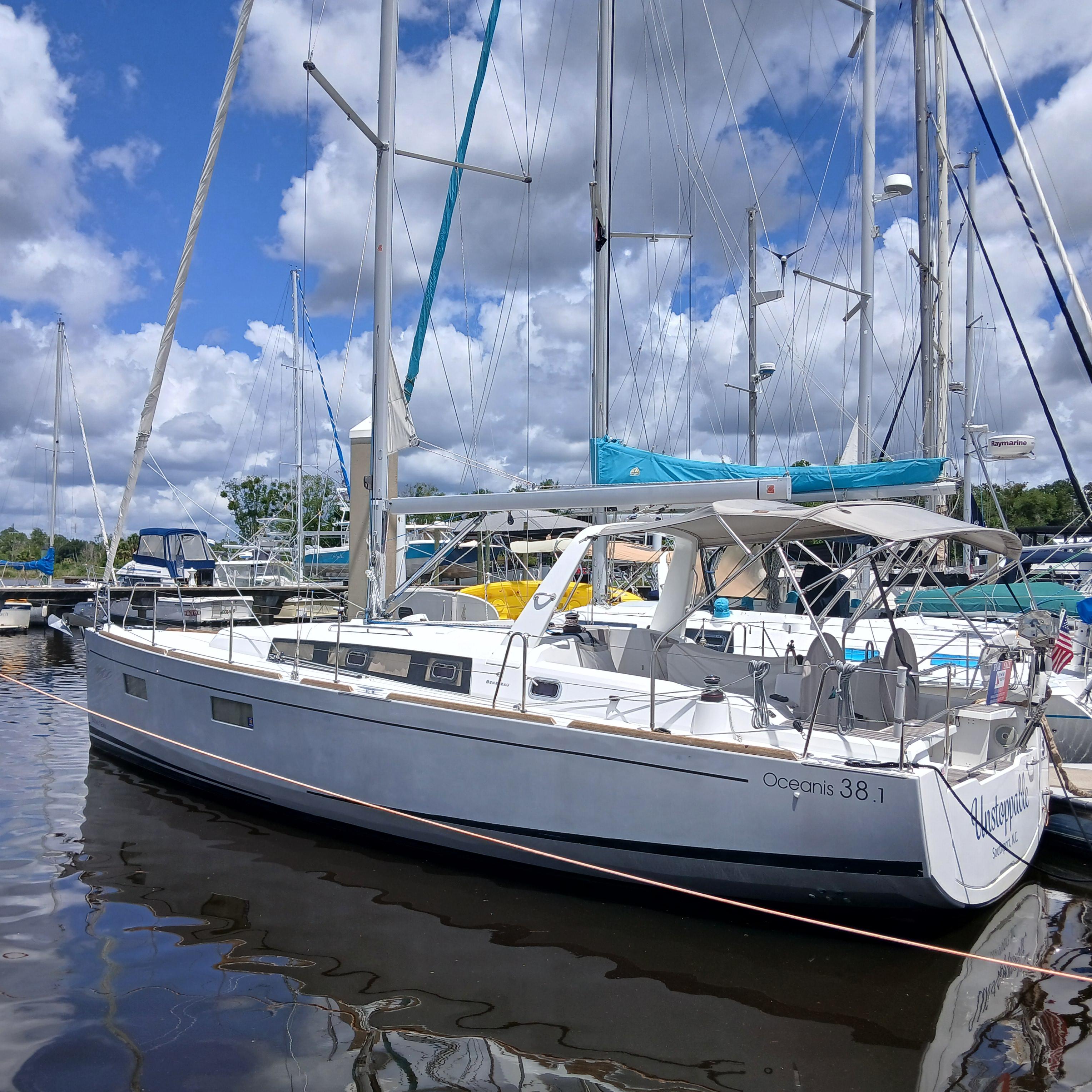 Beneteau Oceanis 38.1 2019 Beneteau Oceanis 38.1 sailboat docked at marina under cloudy sky.